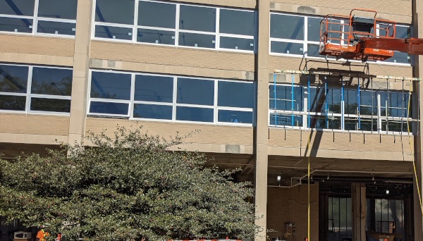 astm e1105 spray rack suspended in front of ribbon windows for testing operations
